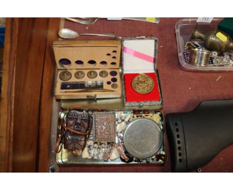 A cased set of scales; an Oriental medallion; shell necklaces; a carved box etc.