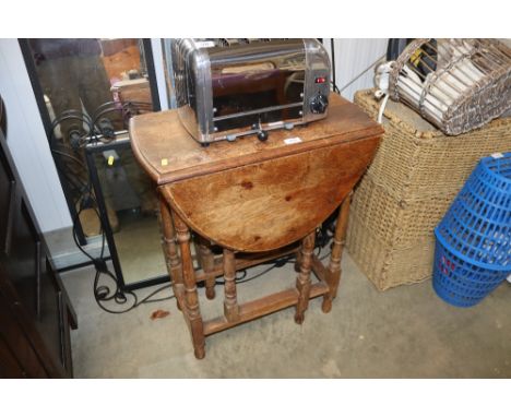 A 1930s oak gate leg tea table 
