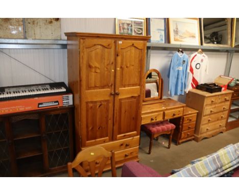 A pine wardrobe fitted two drawers to base