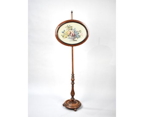 A Late Victorian Mahogany Pole Screen with Oval Rise and Fall Tapestry Panel, Circular Base and Ball Feet 