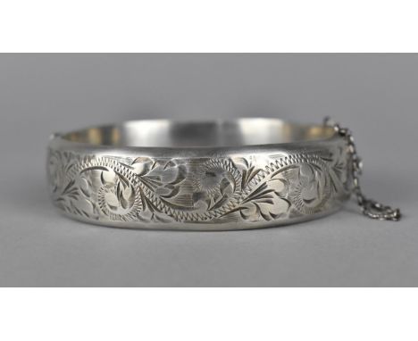 A Silver Bangle with Floral Border and Safety Chain, Hallmark R.P.H. Birmingham 1967 