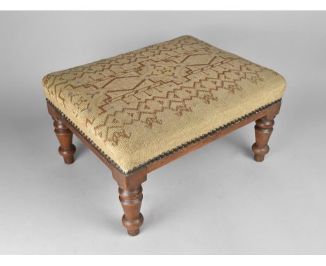 A Tapestry Upholstered Rectangular Footstool with Turned Mahogany Supports, 40cms Long 
