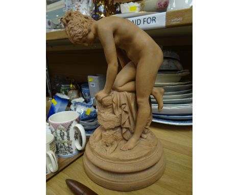A terracotta model of a nude bather on a circular stand