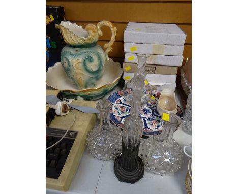 An unusual cut glass oil bottle on a metal work architectural stand, a pair of globular decanters & another together with sun