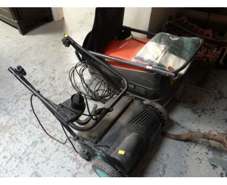 A Flymo Turbo Compact lawn mower together with a lawn spiker