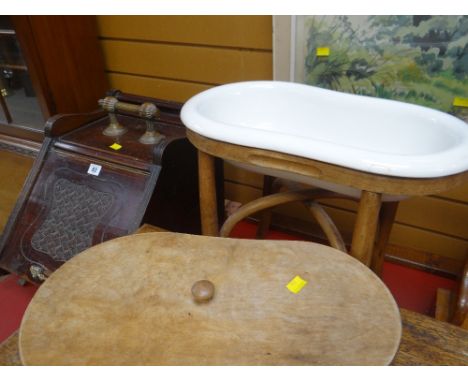 A vintage kidney shaped pottery wash basin on a bentwood stand together with an antique pedonium