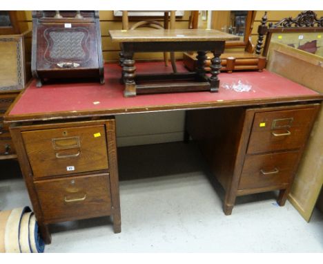 A vintage wooden office desk with two banks of two drawers