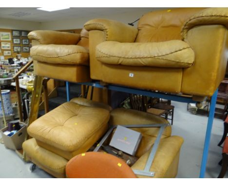 A brown leather three-seater settee & matching armchair with pouffe (possibly from Maples of Tottenham Court Road department 