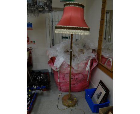 A vintage brass standard lamp on hexagonal stand with shade
