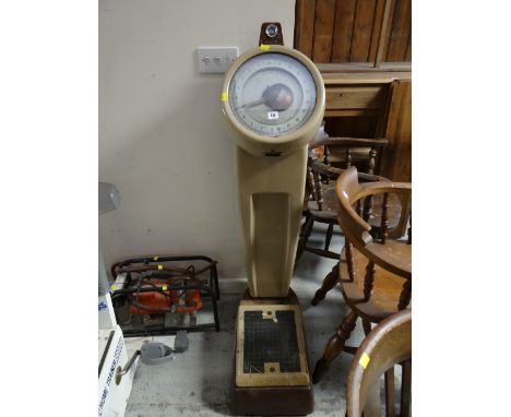 A set of large coin-operated weighing scales