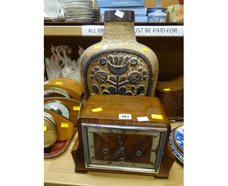 A 1930s polished mantel clock & a stoneware vase