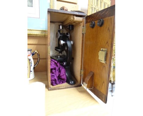 A vintage Beck laboratory microscope in a wooden case