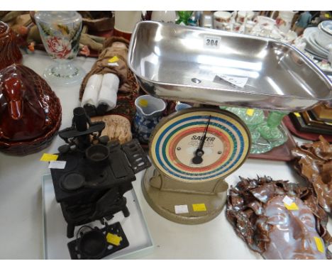 A vintage Salter coin checker & a cast iron model of a range with pans