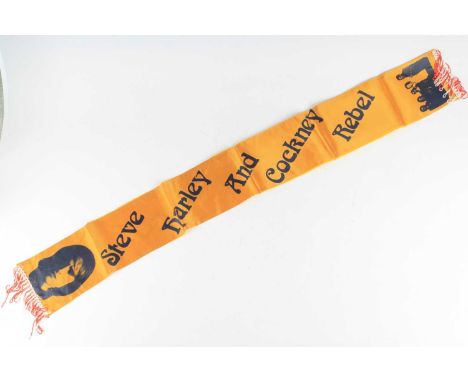 Steve Harley + Cockney Rebel, a 1970's fan club sash/scarf in orange fabric printed with an image of Harley and the band to e