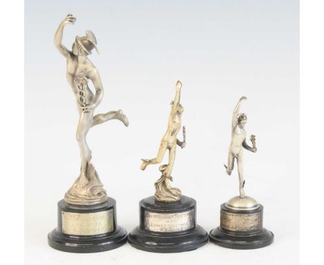 A collection of three 1930's pewter trophies, each in the form of Mercury and raised on an ebonised socle base with presentat