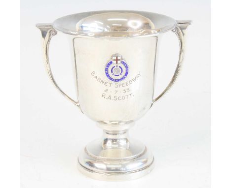 A George V silver trophy cup, of bell shaped with twin handles on a domed foot, having an enamel badge for the North London M