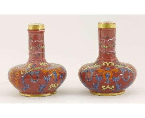 An unusual pair of miniature Scent Bottles,c.1835, possibly Derby, each onion body and short cylindrical neck brightly enamel