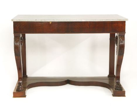 A mahogany console table,19th century, the marble top with a plain frieze, raised on scrolled supports, with stiff leaf caps 