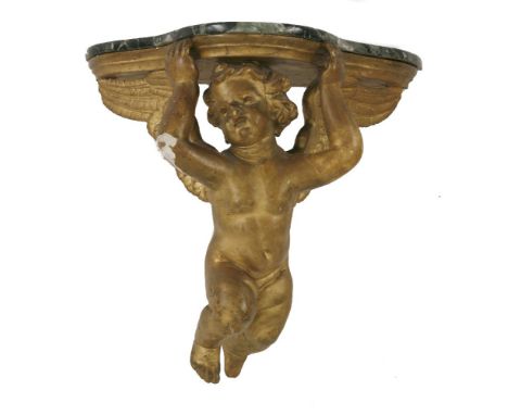 A carved and giltwood console table,early 19th century, modelled as a winged cherub holding a shelf with a later marble top,6