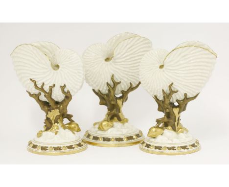 Three Royal Worcester Shell Vases,1880s, each in the form of a nautilus shell, suspended on bronzed coral and gilt seaweed an