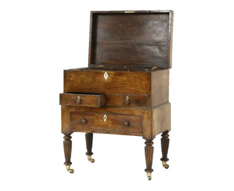 A George IV mahogany workbox on stand,the hinged top revealing fitted hardwood compartments, with reeded covers and ivory kno