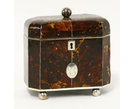 A good tortoiseshell twin compartment tea caddy,19th century, with pewter stringing, ivory borders and white metal feet, knob