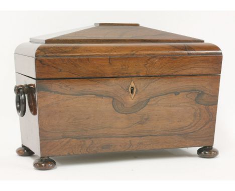 A rosewood tea caddy, c.1830, the lid with upholstered interior housing two caddy boxes and a later cut glass mixing bowl, wi