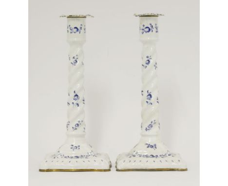 An unusual pair of enamel Candlesticks,c.1790, each with candy twist stem on double flared foot and painted overall with dry 