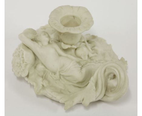 An interesting Parian Chamber Candlestick, mid 19th century, in the form of a woman, bare to the waist and reclining on poppy