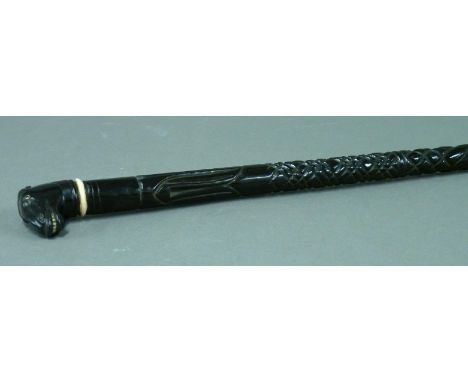 An Anglo-Indian ebony walking stick,19th century, with horse's head finial and ivory collar, 90cm high