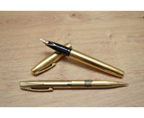 A Sheaffer Imperial 777 aerometric fill fountain pen and propelling pencil set in gold fill with white spot to the cap having