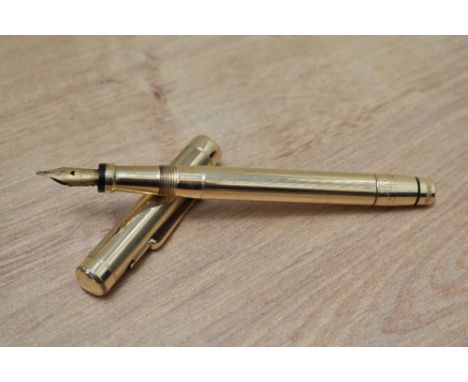 A Mabie Todd twist fill fountain pen in yellow metal engine turned reeded design having Swan 2 14ct