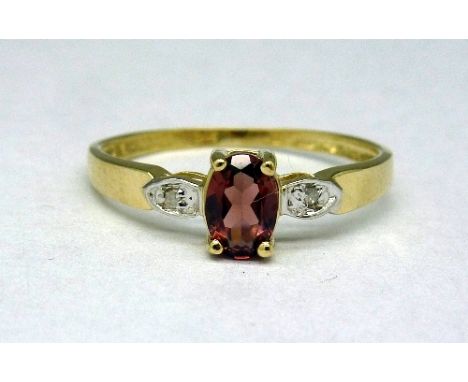 A 9ct gold, garnet and diamond ring, weight 0.9g, size O