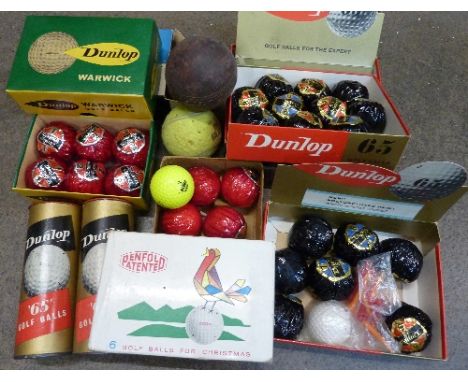 A collection of old, unused, wrapped and boxed golf balls including Dunlop, etc.