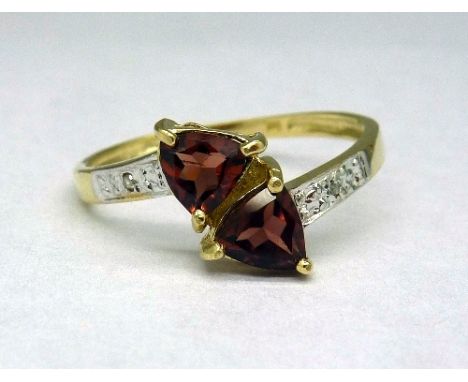 A 9ct gold, garnet and diamond ring, weight 1.4g, size O