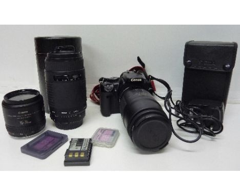A Canon EOS camera with a 100-200mm lens, a Canon lens 35-70mm, a Sigma 75-300mm lens, camera with batteries, charger, memory