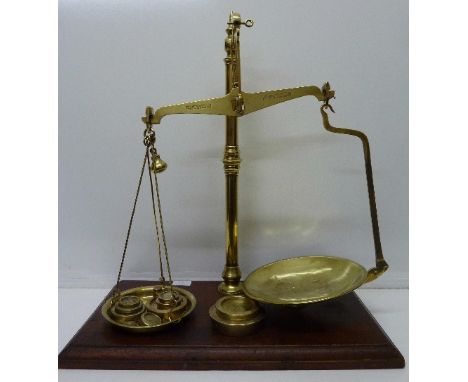 A set of W & T Avery class 3 brass scales and weights on a wooden base