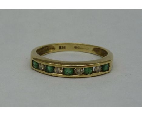 A 9ct gold, diamond and emerald ring, weight 1.7g, size M