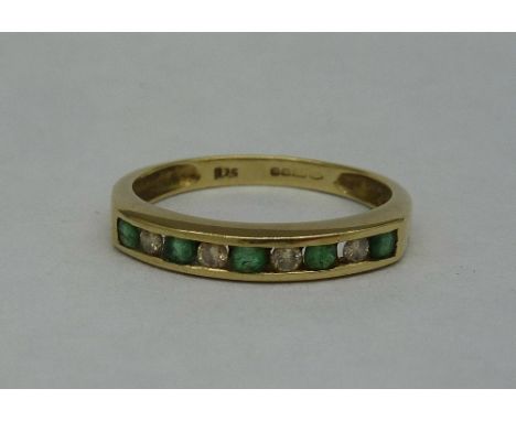 A 9ct gold, diamond and emerald ring, weight 1.7g, size M