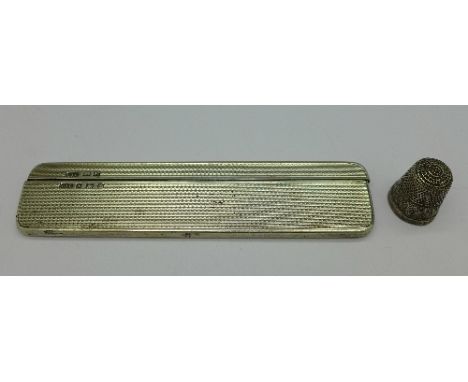 A silver comb case and a silver thimble, case bears initials