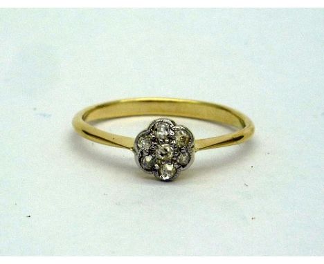 A yellow metal and diamond daisy cluster ring, weight 1.8g, size N