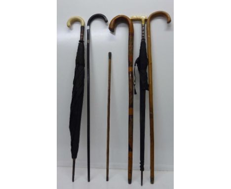 A silver mounted walking cane and umbrella, one other umbrella and a swagger stick with Boys Brigade top and two other walkin