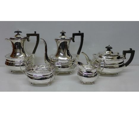 A four piece silver tea service with water jug, London 1911/1912 by Harris & Sons and a silver coffee pot, London 1911 by S &
