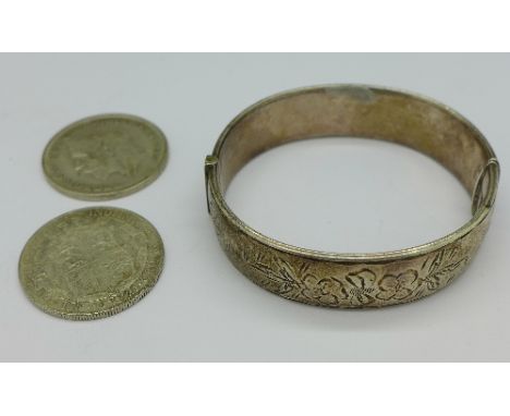 A silver bangle and two George V half crowns, total weight 61g