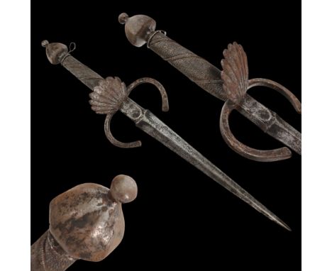 A LARGE ITALIAN LEFT HAND DAGGER, 17TH CENTURY. Straight double-edged steel blade. Guard with flattened ends and a shell-shap