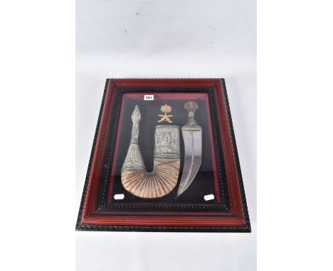 A WOODEN GLAZED BOX STYLE FRAME MEASURING APPROX 50 x 42 cm, containing an ornate Arab Jambiya Dagger and scabbard, the grip 