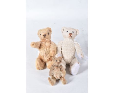 A GOLDEN PLUSH MINIATURE BEAR, c.1920's, possibly Steiff but missing button from ear, original black button eyes, horizontal 