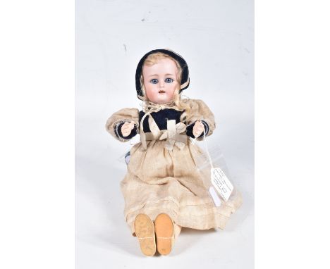 A KAMMER &amp; REINHARDT BISQUE HEAD DOLL, c.1900, sleeping blue glass eyes, wear to lids, open mouth showing four teeth, pie