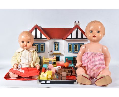 A WOODEN DOLLS HOUSE, c.1950's, modelled as a mock Tudor villa with half-timbered gables, double front opening to reveal four