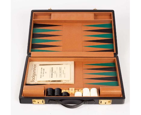 A travel backgammon set retailed by Harrods, complete with dice, shakers and keys, 44cm x 28cm when closedGemerally very good